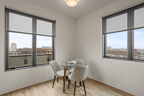 A room with a balcony at Aug Smith on Main, with a table and chairs.