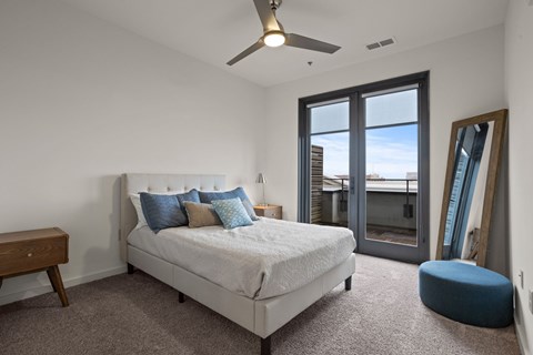 Aug Smith on Main bedroom with a large bed and a ceiling fan.