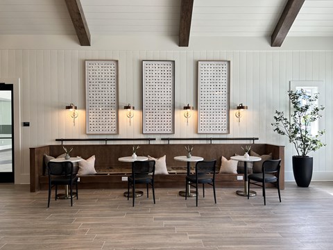 a dining room with tables and chairs and a bar
