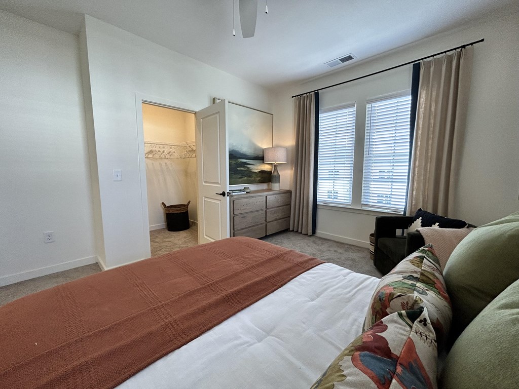 a bedroom with a large bed and a large window