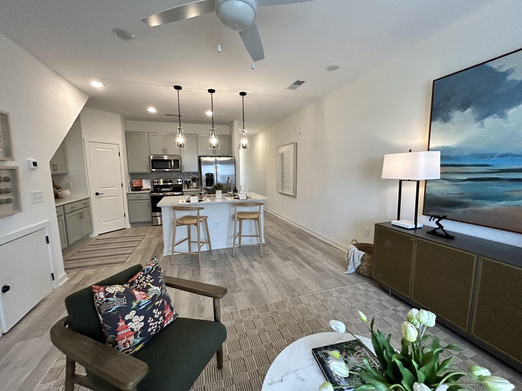 the view of the living room and kitchen from the balcony