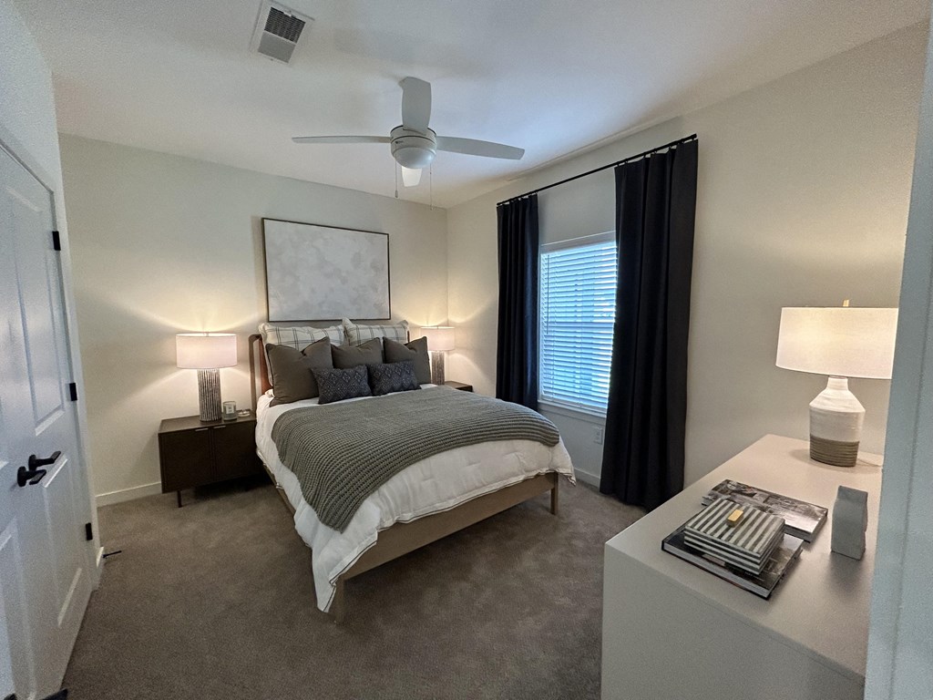 a bedroom with a bed and a ceiling fan