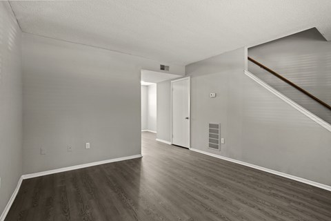 A room with a staircase and a door.