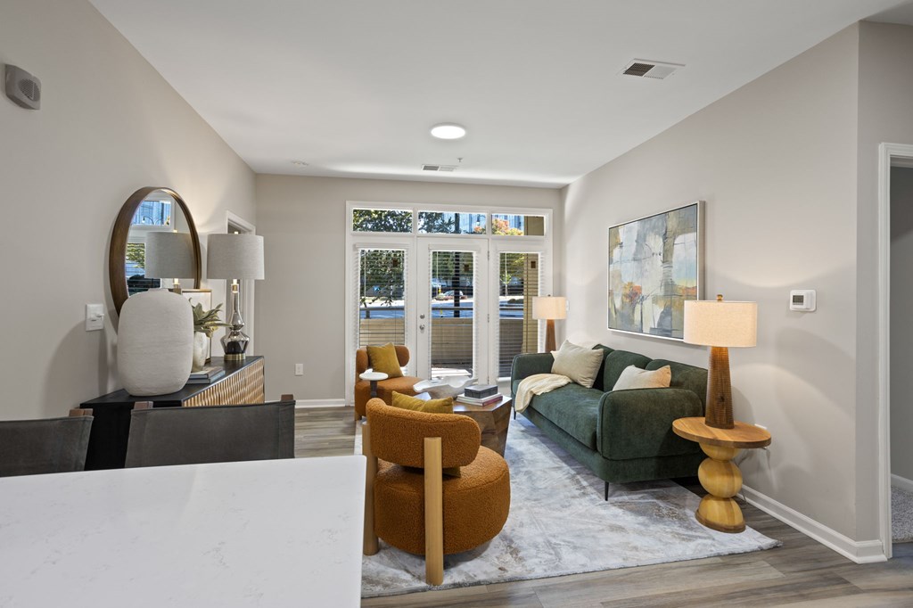 Flatiron West Trade Apartments staged model unit living room with luxury vinyl tile flooring and quartz countertops