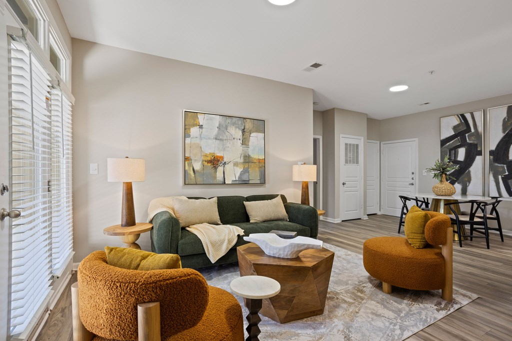 Flatiron West Trade Apartments interior model unit with chairs, small table and pineapple shaped desk pot