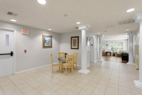 A dining room with a table and chairs.