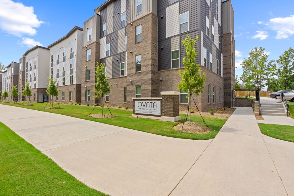 A sign that reads Ovata at Reedy Creek in front of Ovata at Reedy Creek Senior Apartments in Charlotte NC.