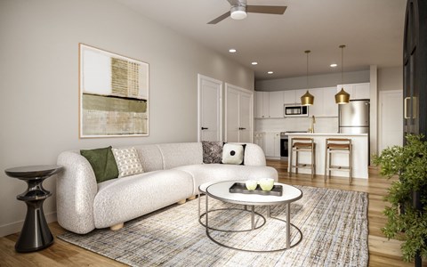 A modern living room with a white sofa and a coffee table.