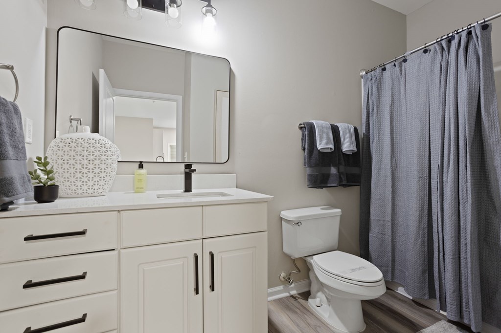 Flatiron West Trade Apartments staged model unit bathroom with a quartz countertop