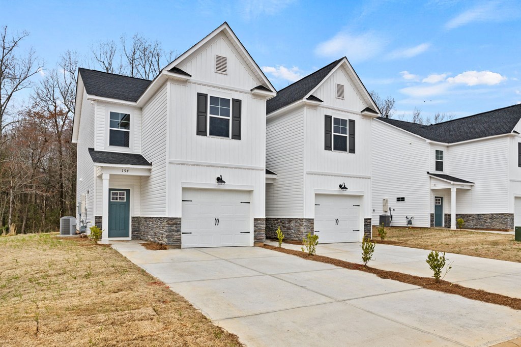 a white house with a driveway in front of it