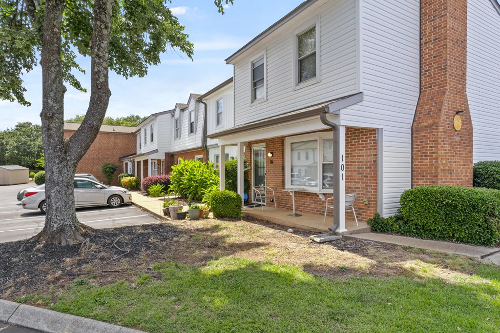 A tree is in front of a house.