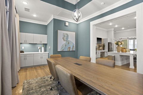 A dining room with a long table and chairs.
