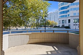 A sand pit in the middle of a city with a tree in the background.