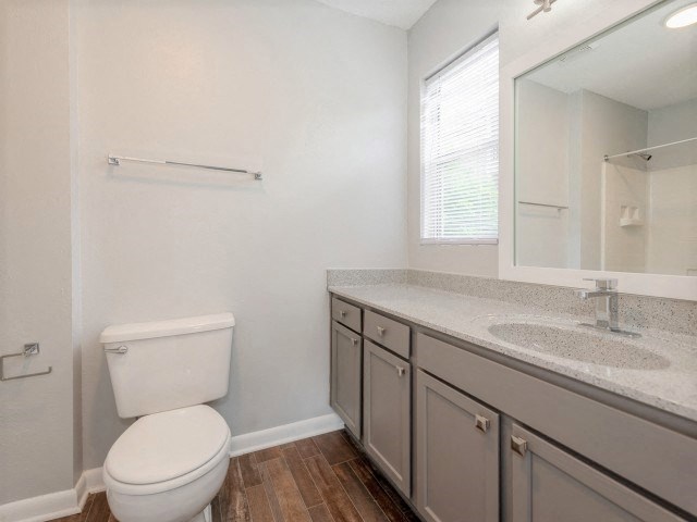 A white toilet sits next to a sink in a bathroom.