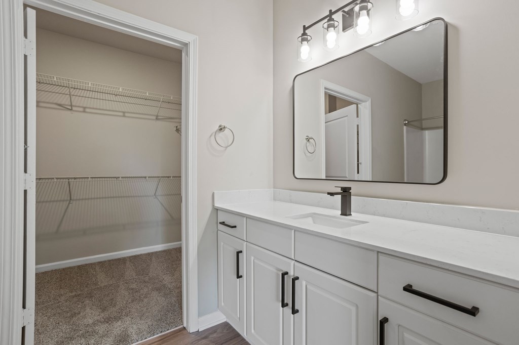 Flatiron West Trade Apartments staged model unit bathroom with a quartz countertop