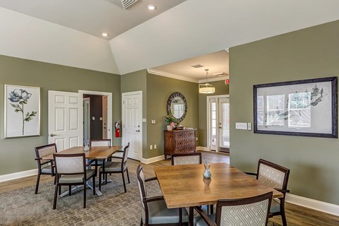 A dining room with a wooden table and chairs.