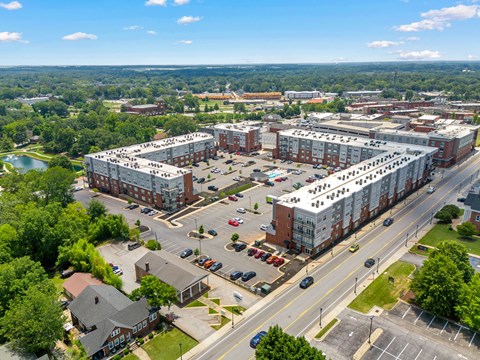 A large building complex with a parking lot in front.