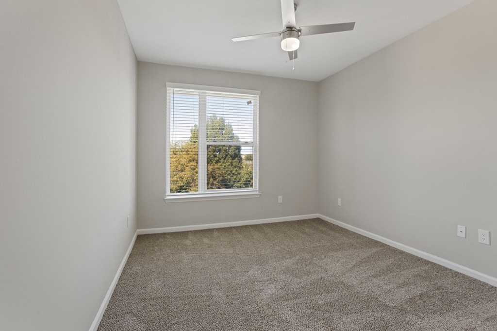 Flatiron West Trade Apartments gray carpeted bedroom