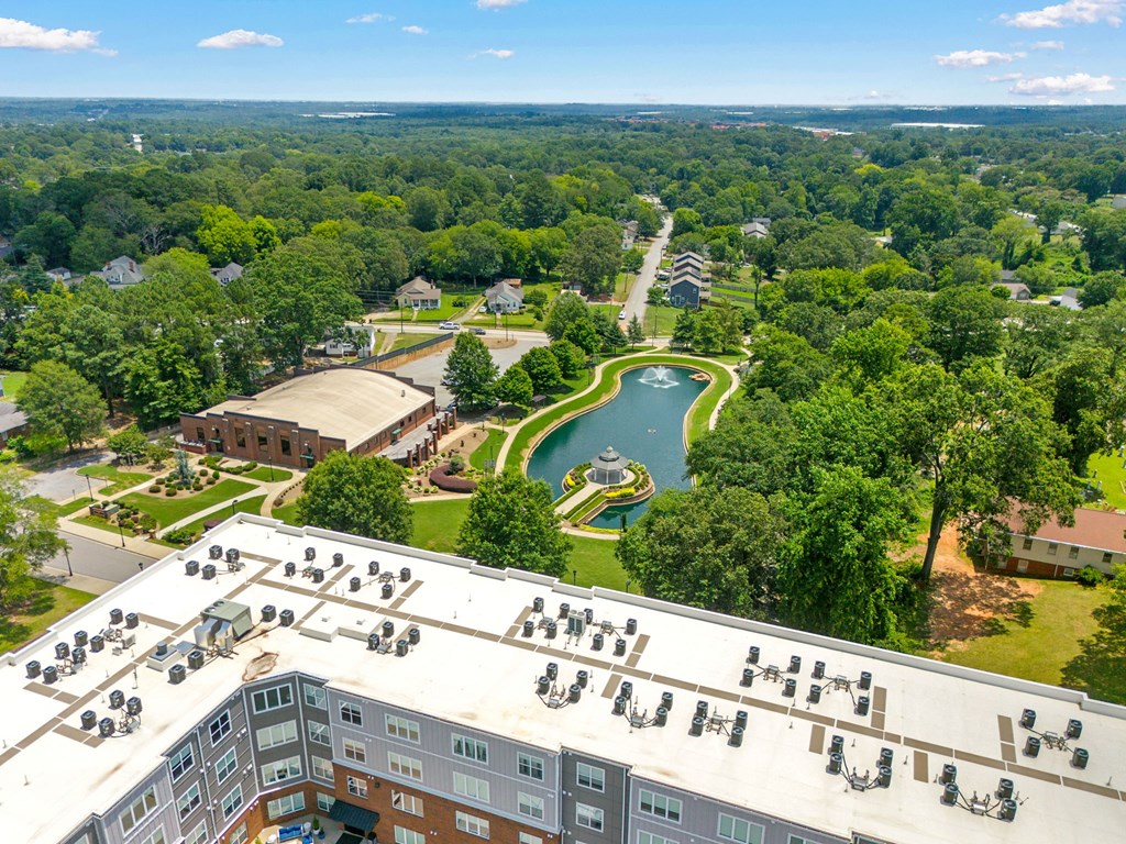 A bird's eye view of a resort with a pool and a building with a lot of windows.