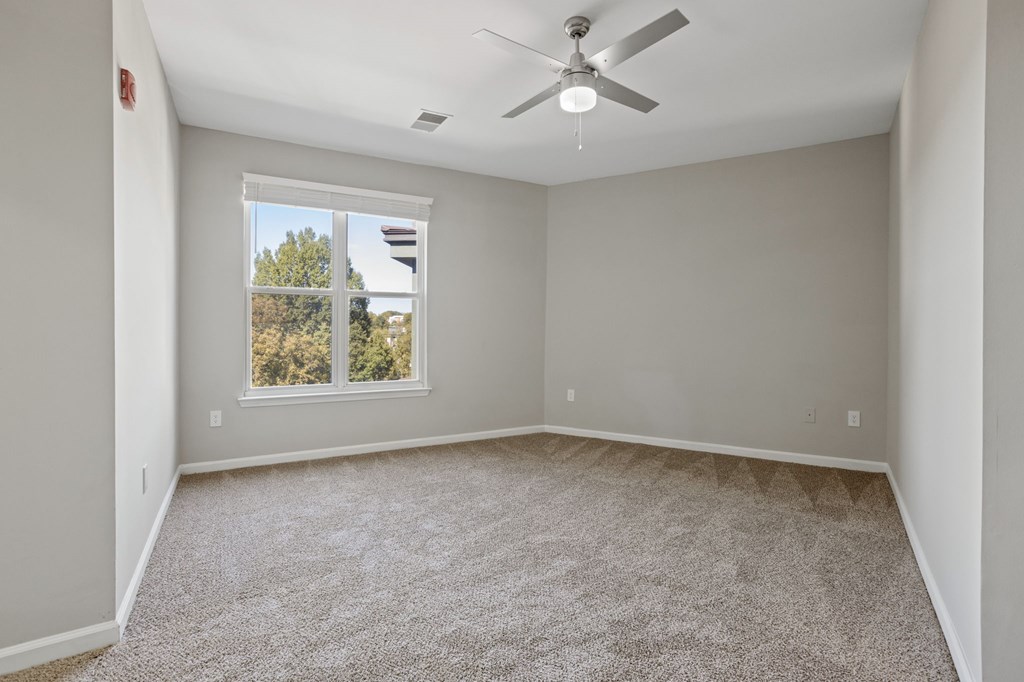 Flatiron West Trade Apartments gray carpeted bedroom
