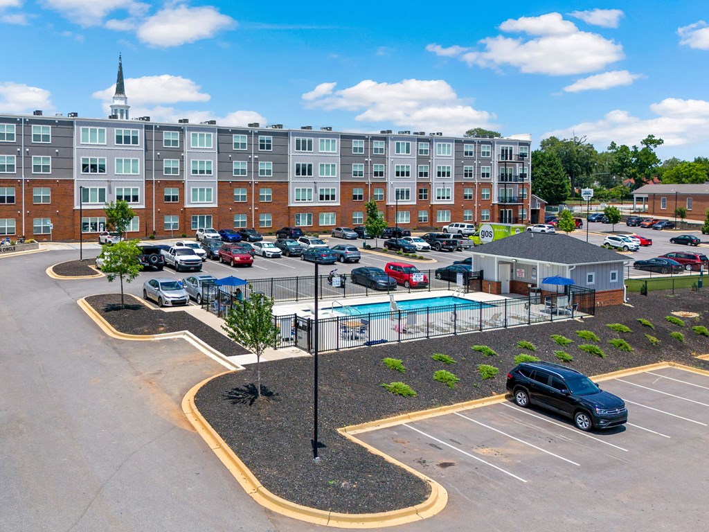 Park View Greer's parking lot in the middle of the complex, with a pool in the middle.