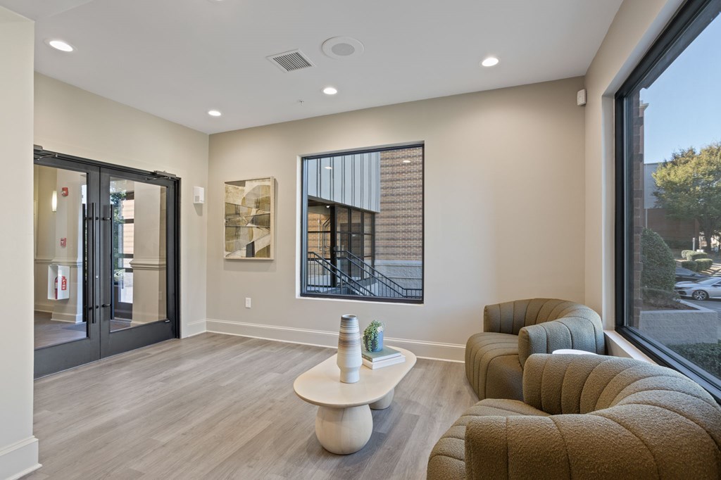 Flatiron West Trade Apartments leasing office with two chairs and a coffee table