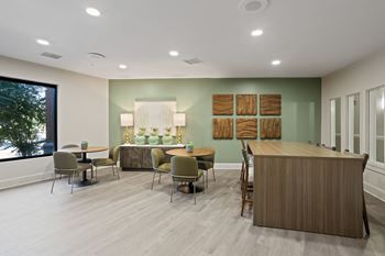 A room with a reception desk and chairs.