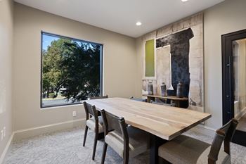 A dining room with a wooden table and chairs.