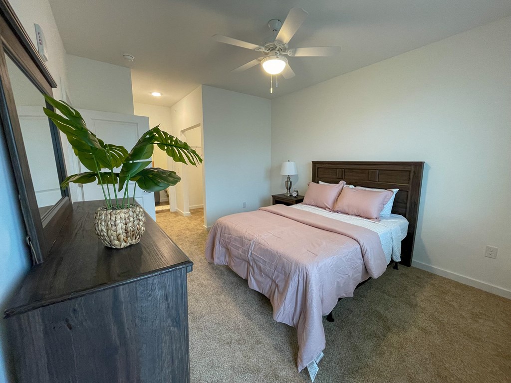 Pet-Friendly Apartments in Greenville, SC - Alston - Bedroom with Full-Size Bed, Nightstand, Ceiling Fan, and Rug.
