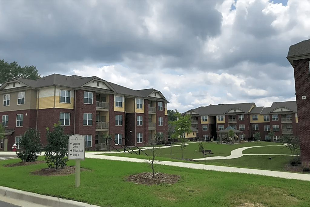 an exterior view of an apartment building on a cloudy day