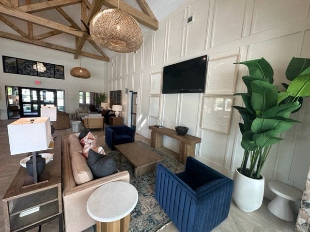 a living room with a large plant and a couch