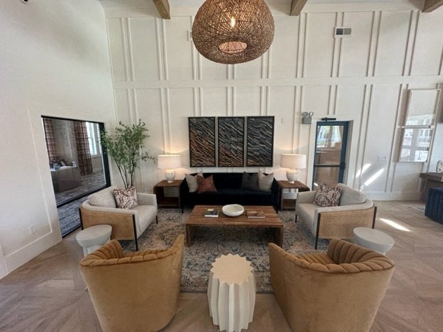 a living room with a couch and chairs and a table