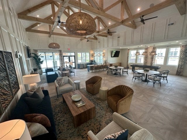 a large living room with couches and chairs and a table