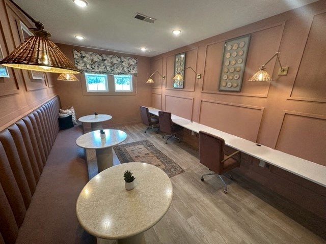 a room with tables and chairs and a bench