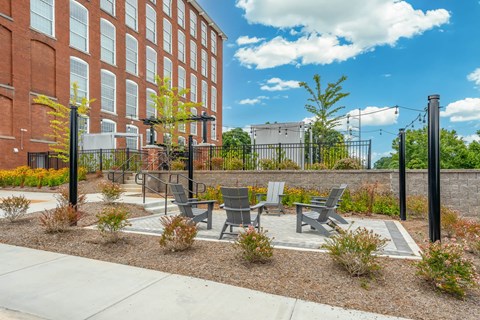 Chairs outside of the pool in Converse Mill Lofts Apartments in Spartanburg SC
