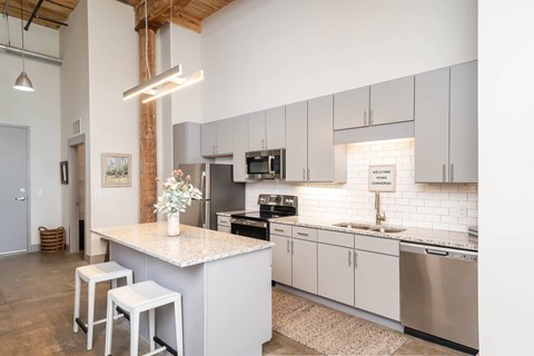 Converse Mill Lofts Kitchen with Stainless Steel Energy Efficient GE Appliances and Granite Countertops