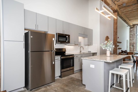 Converse Mill Lofts Kitchen with Stainless Steel Energy Efficient GE Appliances and Granite Countertops