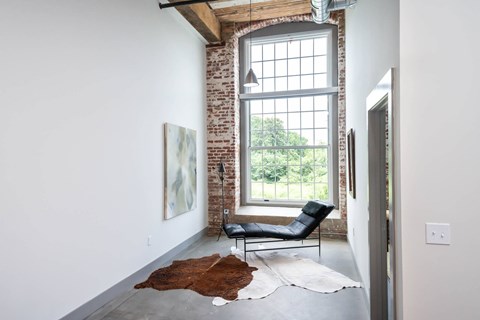 Converse Mill Lofts Luxury Apartments Model Unit Hallway with High Ceilings and Exposed Wood and Brick