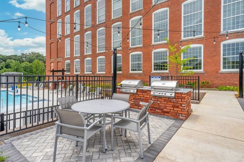 Converse Mill Lofts Apartments Table outside of Pool