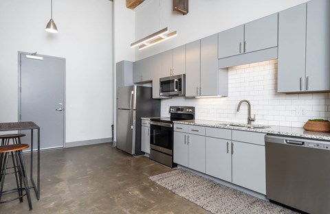 Converse Mill Lofts Kitchen with Stainless Steel Energy Efficient GE Appliances and Granite Countertops