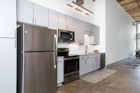 Converse Mill Lofts Kitchen with Stainless Steel Energy Efficient GE Appliances and Granite Countertops