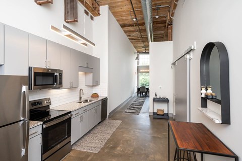 Kitchen in Converse Mill Lofts Apartments in Spartanburg SC with Stainless Steel Appliances and granite countertops
