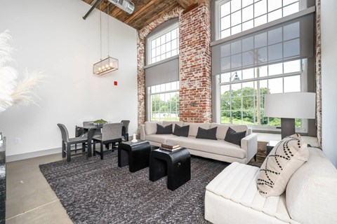 Converse Mill Lofts Luxury Apartments Model Unit Living Room with High Ceilings and Exposed Wood