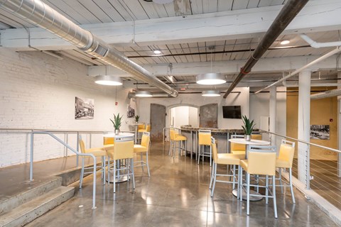 Converse Mill Lofts co-working station with two tables and a TV