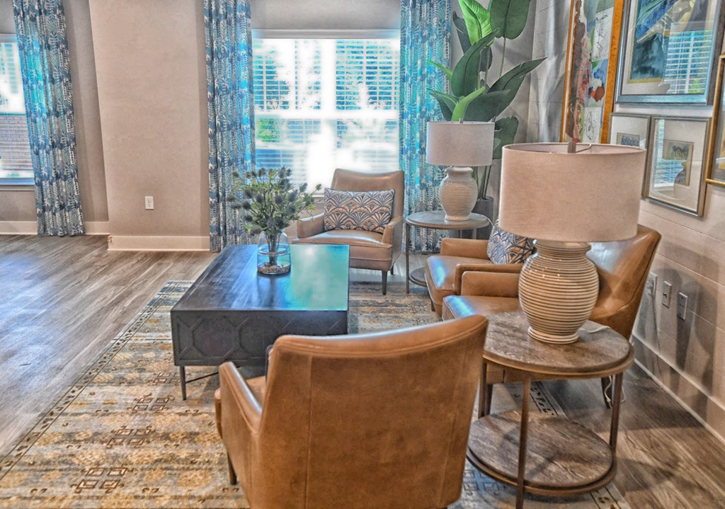 A living room with a brown leather chair and a glass table.