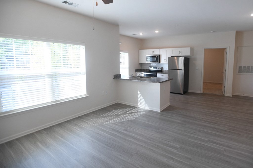 A kitchen area with a refrigerator, microwave, and oven.