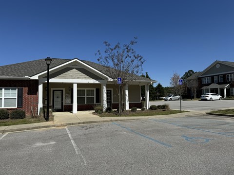 A building with a parking lot in front of it.