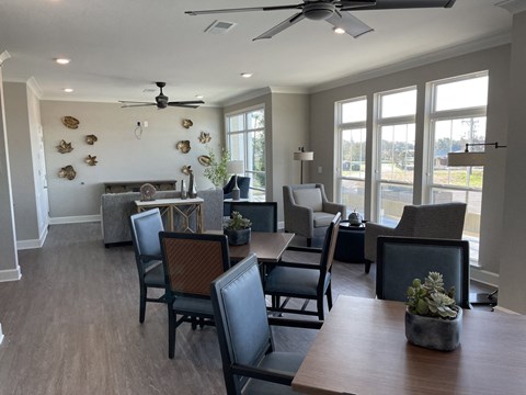 A dining room with a table and chairs.