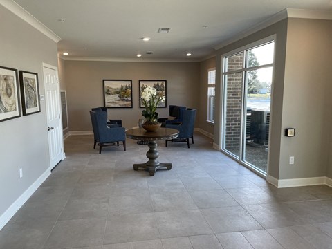 A living room with a table and chairs.