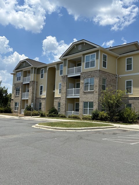 an empty street in front of an apartment building